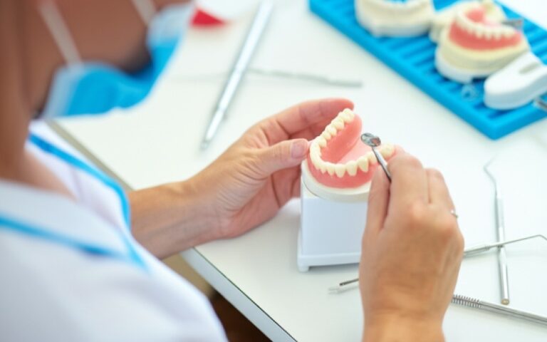 Dental technician crafting custom denture