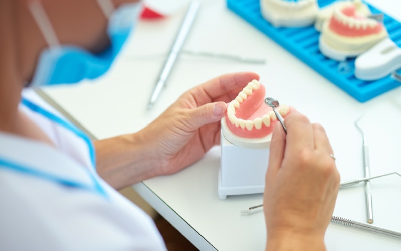 Dental technician crafting custom denture