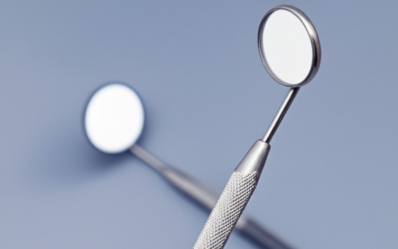A close-up of an ergonomic dental mirror handle