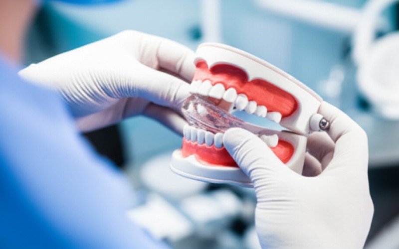 Dentist fitting an NTI splint