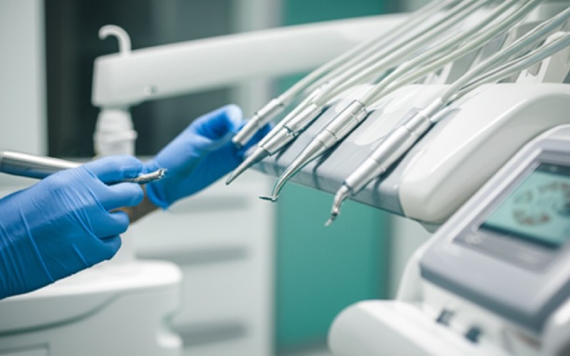 Dentist selecting a dental handpiece