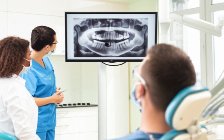Dentist showing patient a dental x-ray