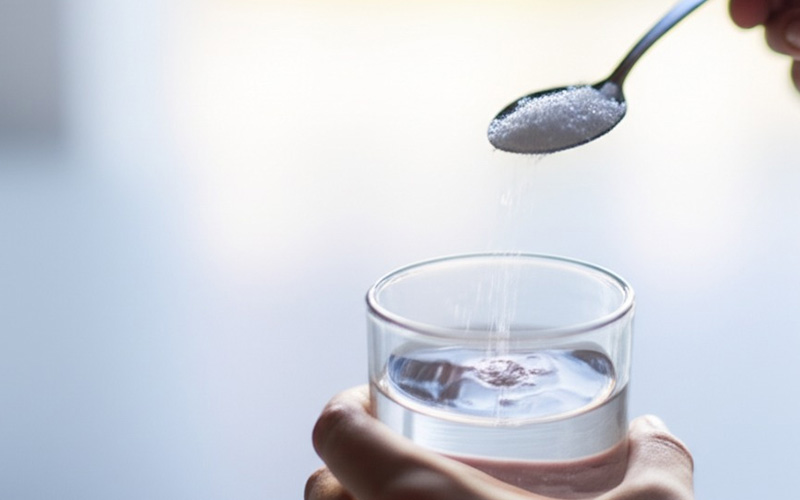 Mixing a saltwater rinse in a glass