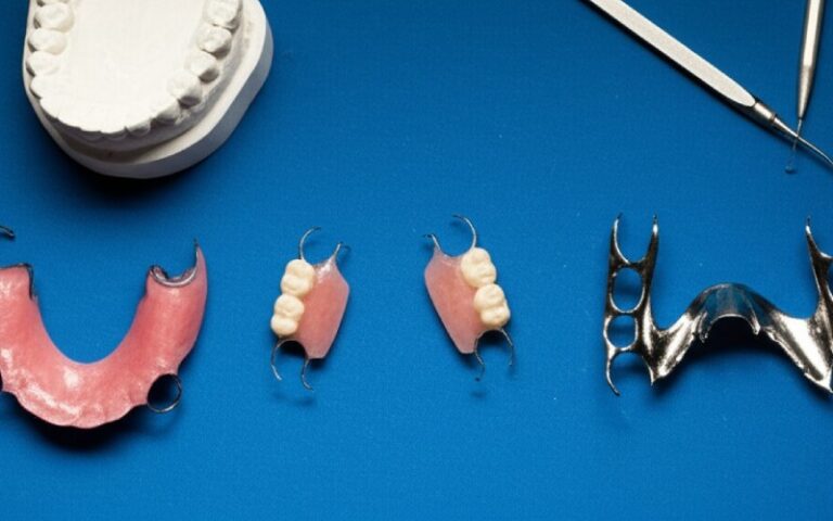 Three types of partial dentures on a lab workbench