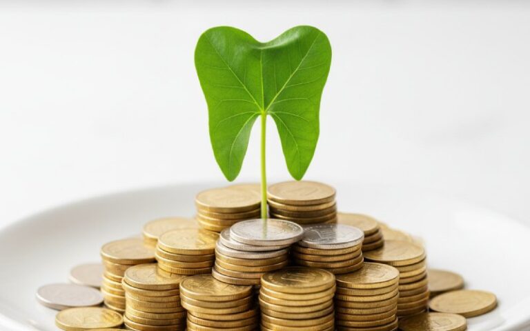 A tooth-shaped plant growing from coins