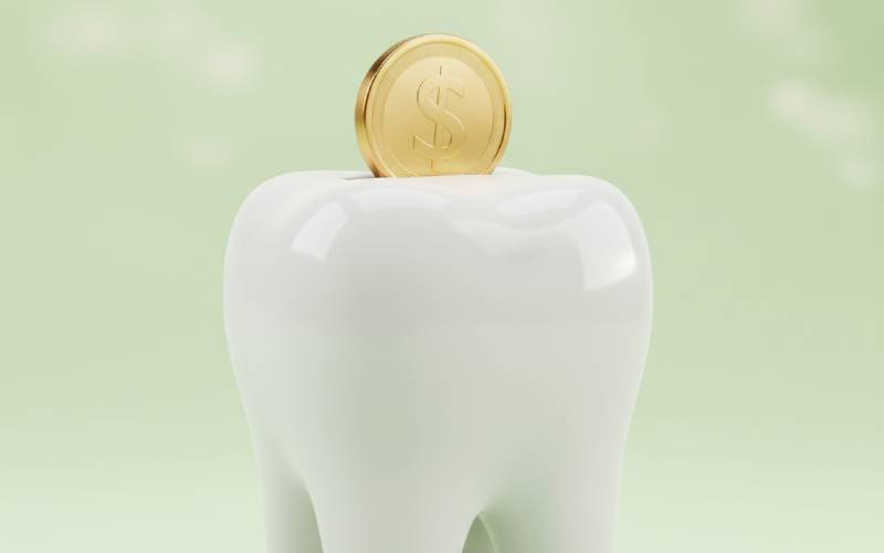 Tooth-shaped piggy bank with a coin