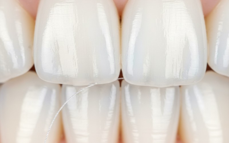 Close-up of flossing healthy teeth